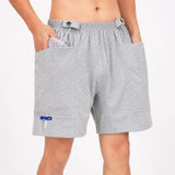 Person wearing HAXOR adaptive catheter drainage bag shorts with discreet external pockets for securely carrying a 2000ml urine drainage bag.