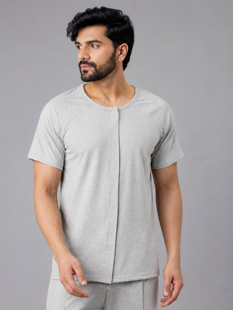 Man wearing a light grey front-open recovery T-shirt with Velcro closure for easy dressing after surgery.