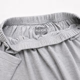 Close-up of HAXOR adaptive catheter shorts showing elastic waistband, secure catheter tube holder strap and premium breathable cotton fabric.