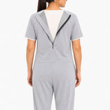 Close-up of open diagonal back zipper on grey adaptive jumpsuit for easy dressing